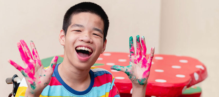 Boy with finger painted hands
