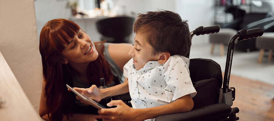 caregiver and child in wheelchair