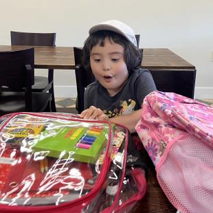 Boy with headphones and backpack